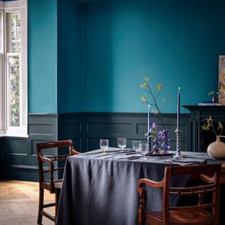 dining room with teal and dark blue walls