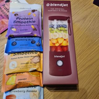 The BlendJet 2 next to a range of smoothie packs