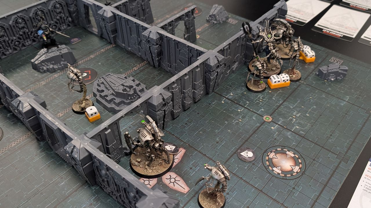 An in-progress Tomb World game with miniatures, terrain, dice, and cards visible