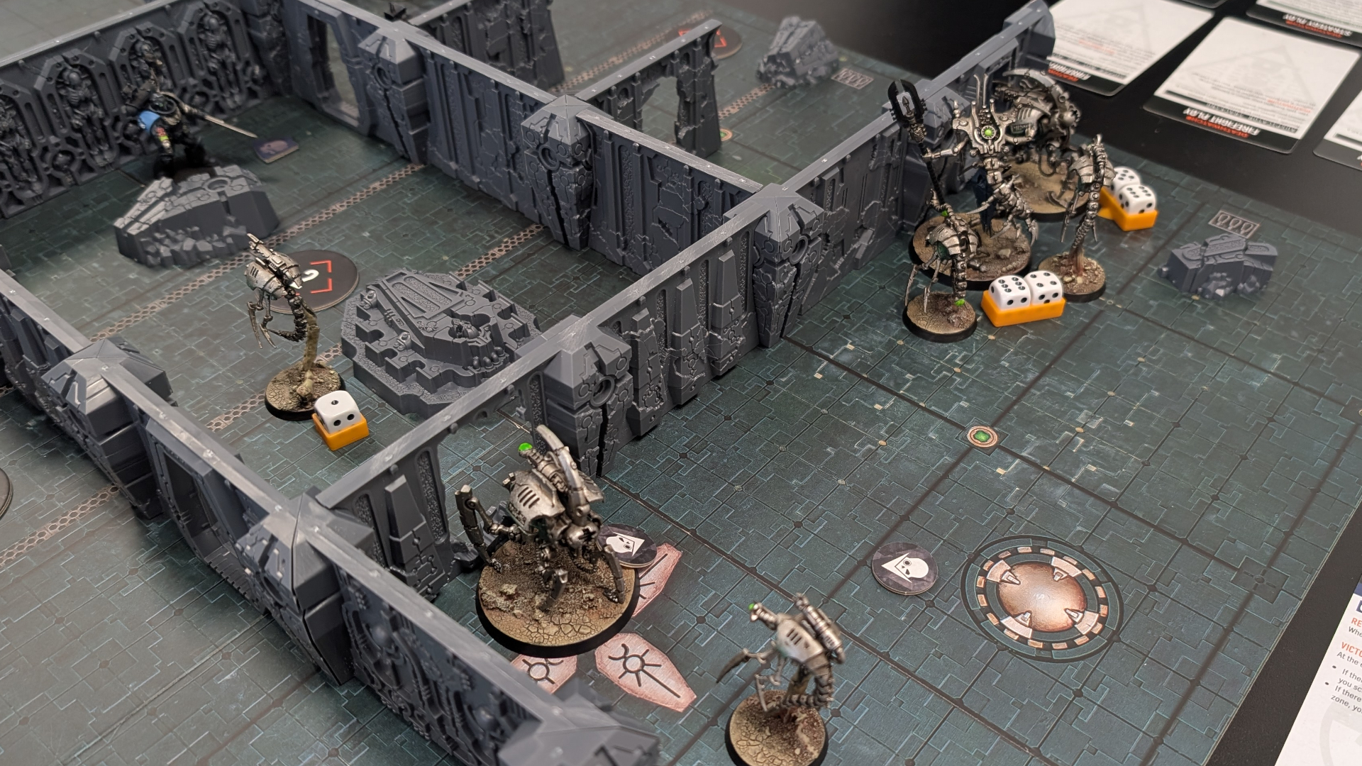 An in-progress Tomb World game with miniatures, terrain, dice, and cards visible