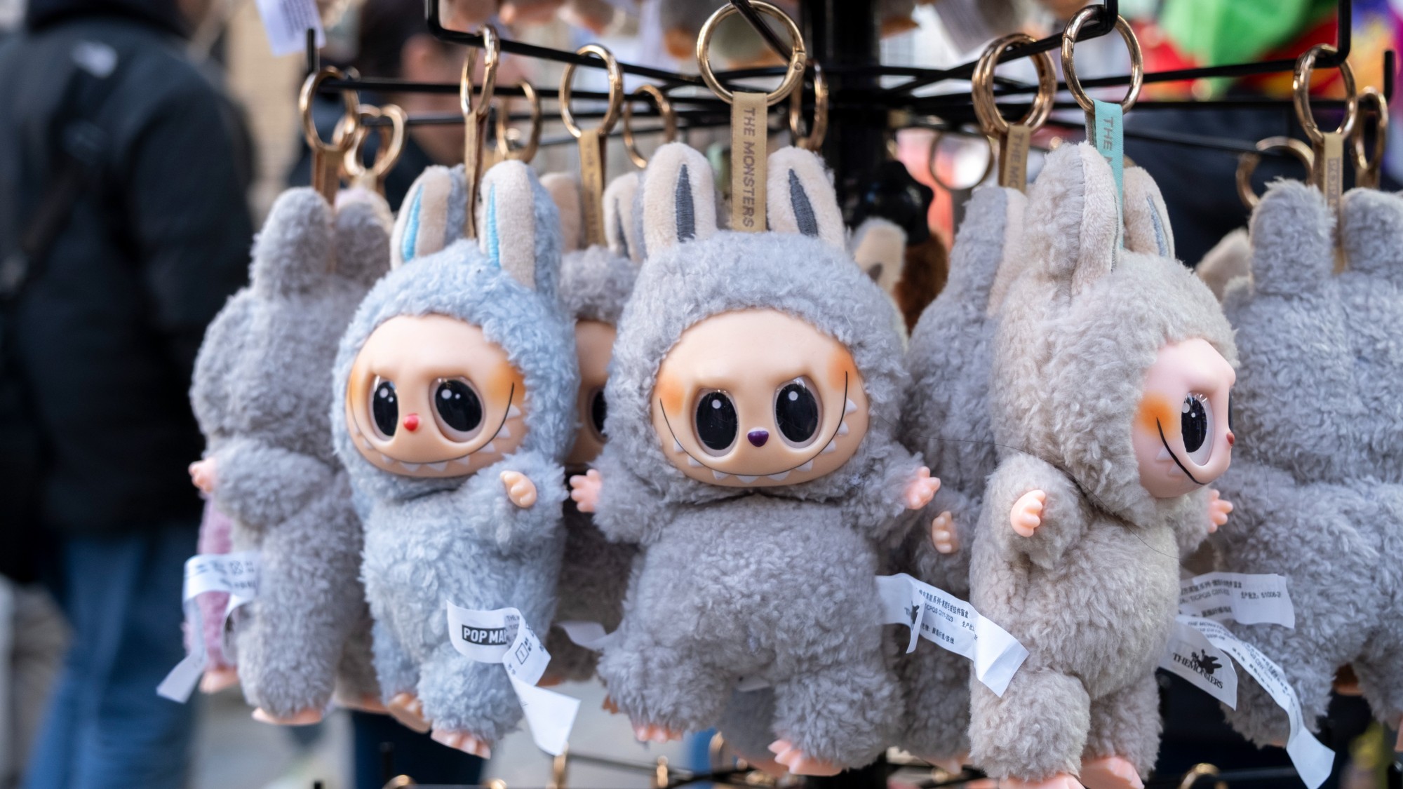 Labubu keychains hanging from a vendor stall