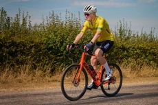 Bob Munro on his red bike wearing a yellow jersey