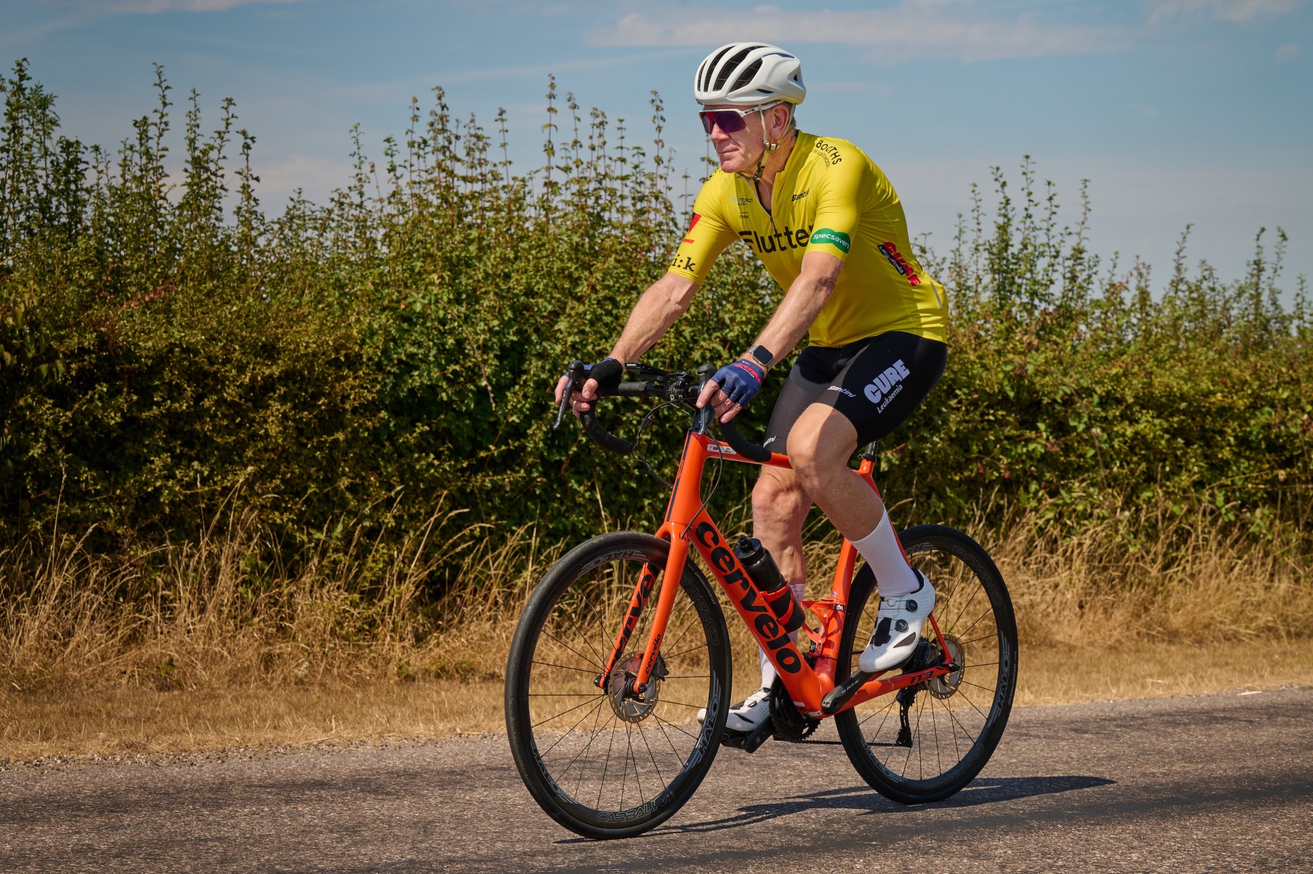 Bob Munro on his red bike wearing a yellow jersey