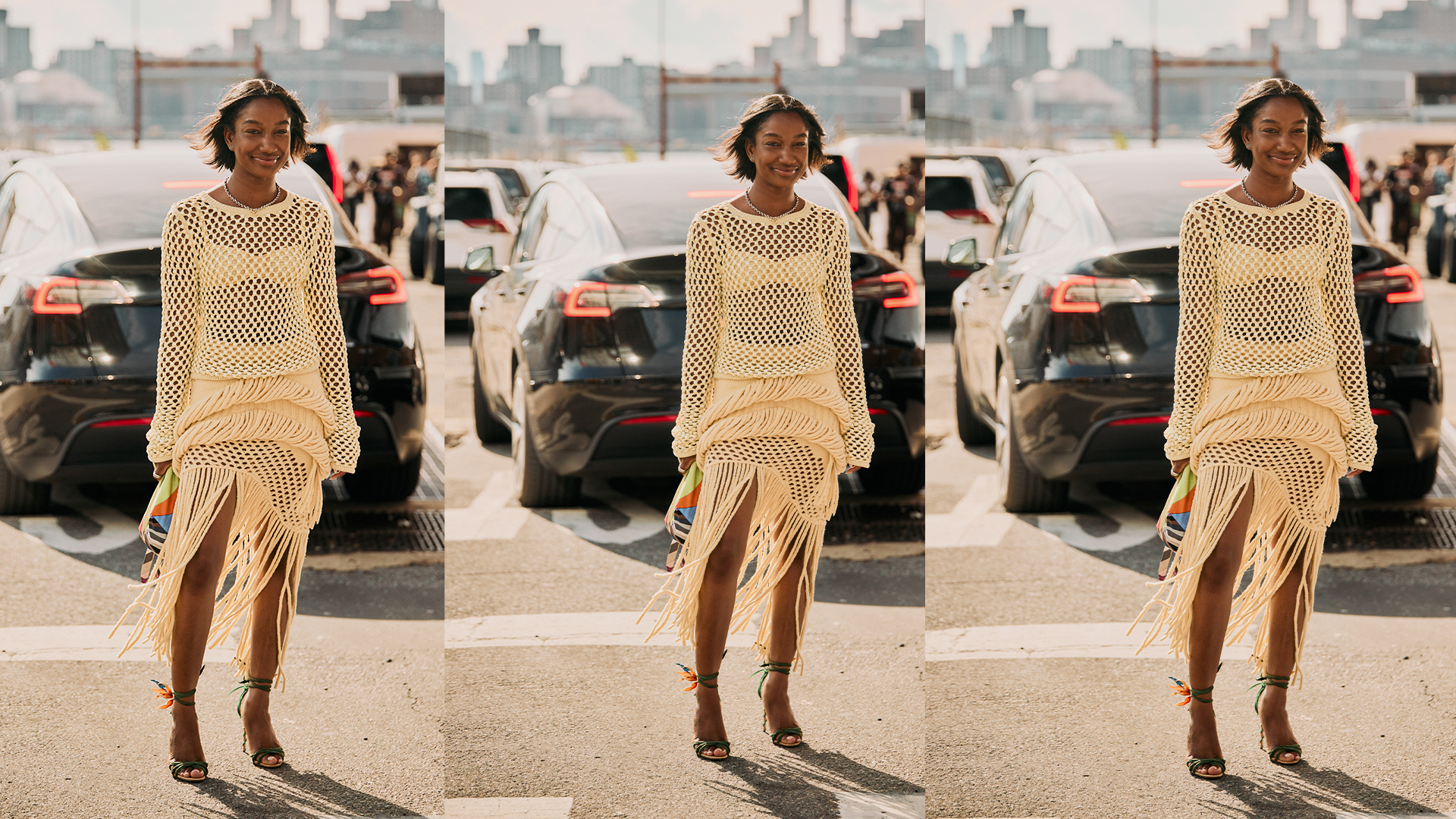 Woman wears crochet top and skirt set with heels and colorful clutch while posing in the NYC streets.