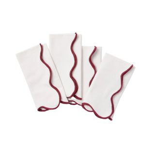 white scalloped napkins with a red trim
