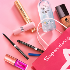 Avon beauty products coming out of a Superdrug bag