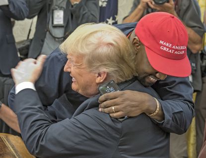 Kanye West embracing Donald Trump