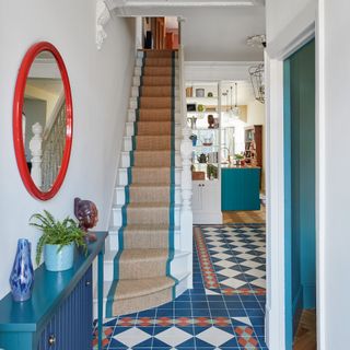 classic tiled hallway and stairwell with a view into a large kitchen diner