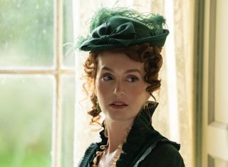 leighton meester in a green gilded age hat and dress in a still from the buccaneers season2 2