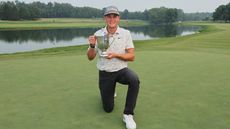Vincent Norrman of Sweden celebrates with the trophy after putting in to win on the 18th hole during the sudden death playoff against Nathan Kimsey of England during the final round of the Barbasol Championship