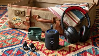 Travel gadgets with a suitcase in the background