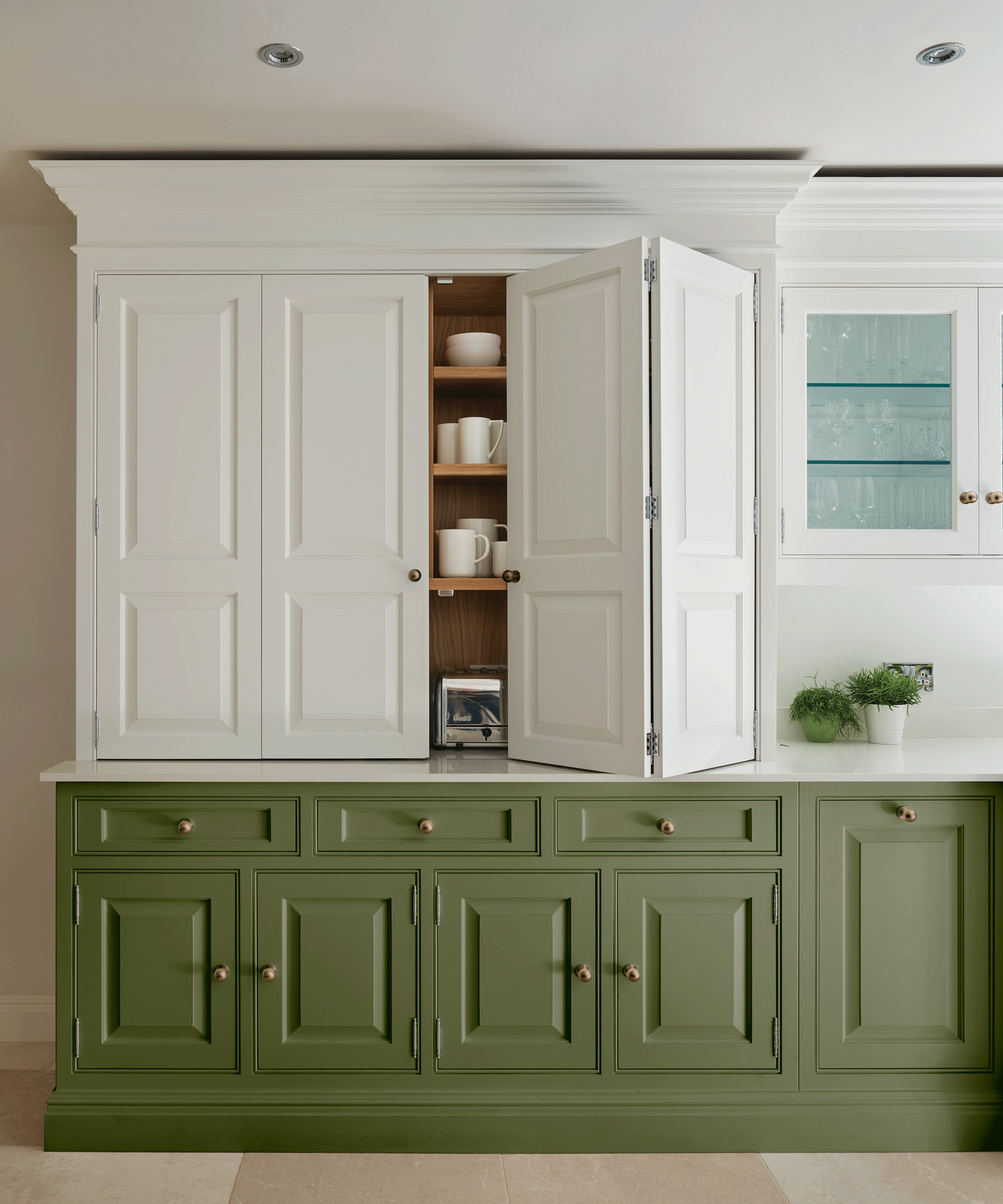 Two-tone kitchen with green and white cabinetry