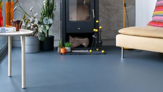 grey rubber floor in living room with log burning stove