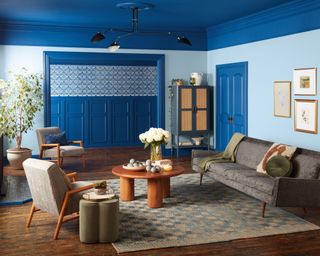 living room with dark blue ceiling and door, and light blue walls