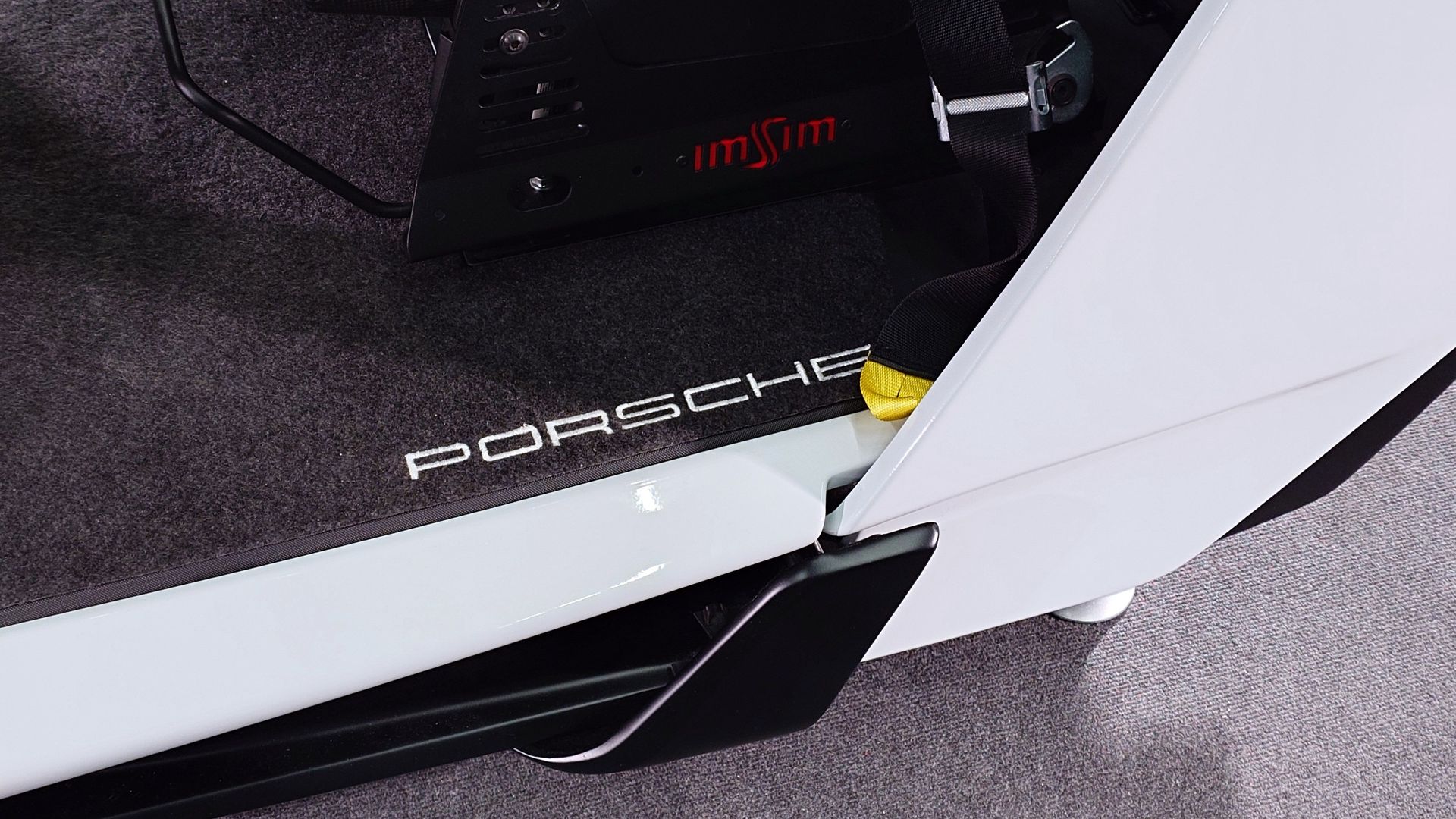 Closeup photo of the ImSim Porsche Raceborn simulator showing the Porsche logo