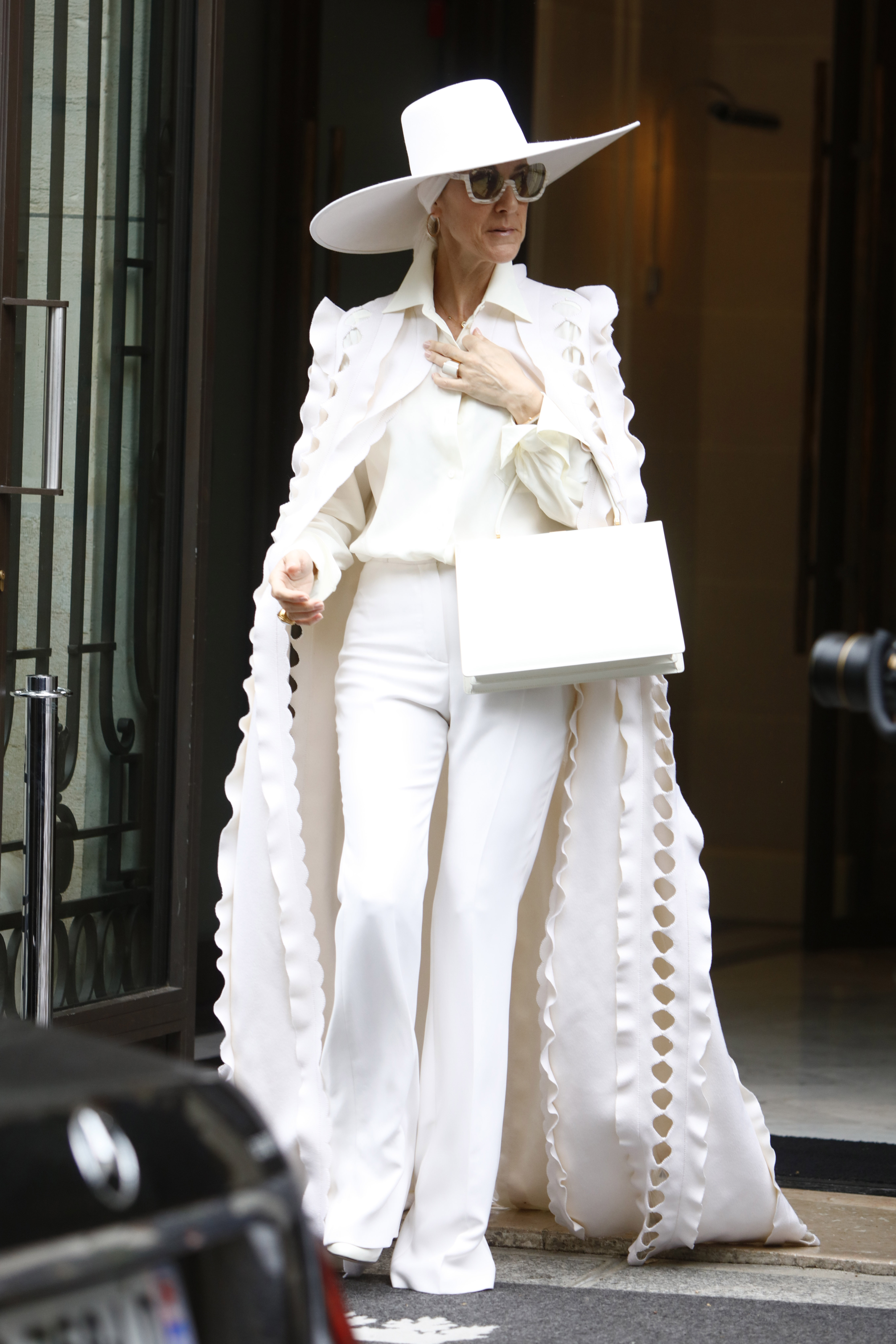 Celine Dion wore a white Celine bag with her suit set in July 2017
