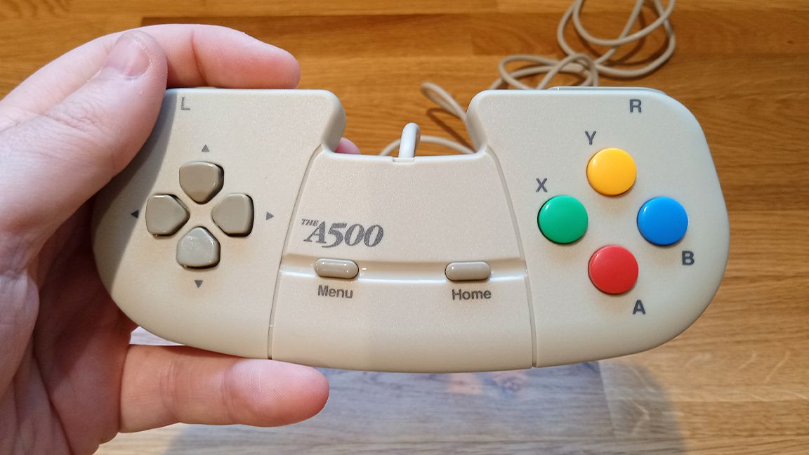 A photo of the A500 Mini gamepad being held, for an Amiga 500 mini review