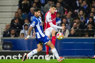 Kai Havertz of Arsenal (R) passes the ball while is blocked by Alan Varela of FC Porto (L) during the UEFA Champions League 2023/24 round of 16 first leg match between FC Porto and Arsenal FC at Estadio do Dragão on February 21, 2024 in Porto, Portugal.