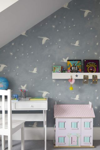 A kids bedroom with an awkward alcove with a wallpaper pasted deftly