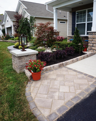 A small front yard with paved entryway path