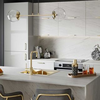 kitchen with sink hanging light and wine glasses