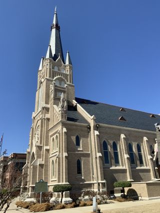The exterior of a church against a blue sky.