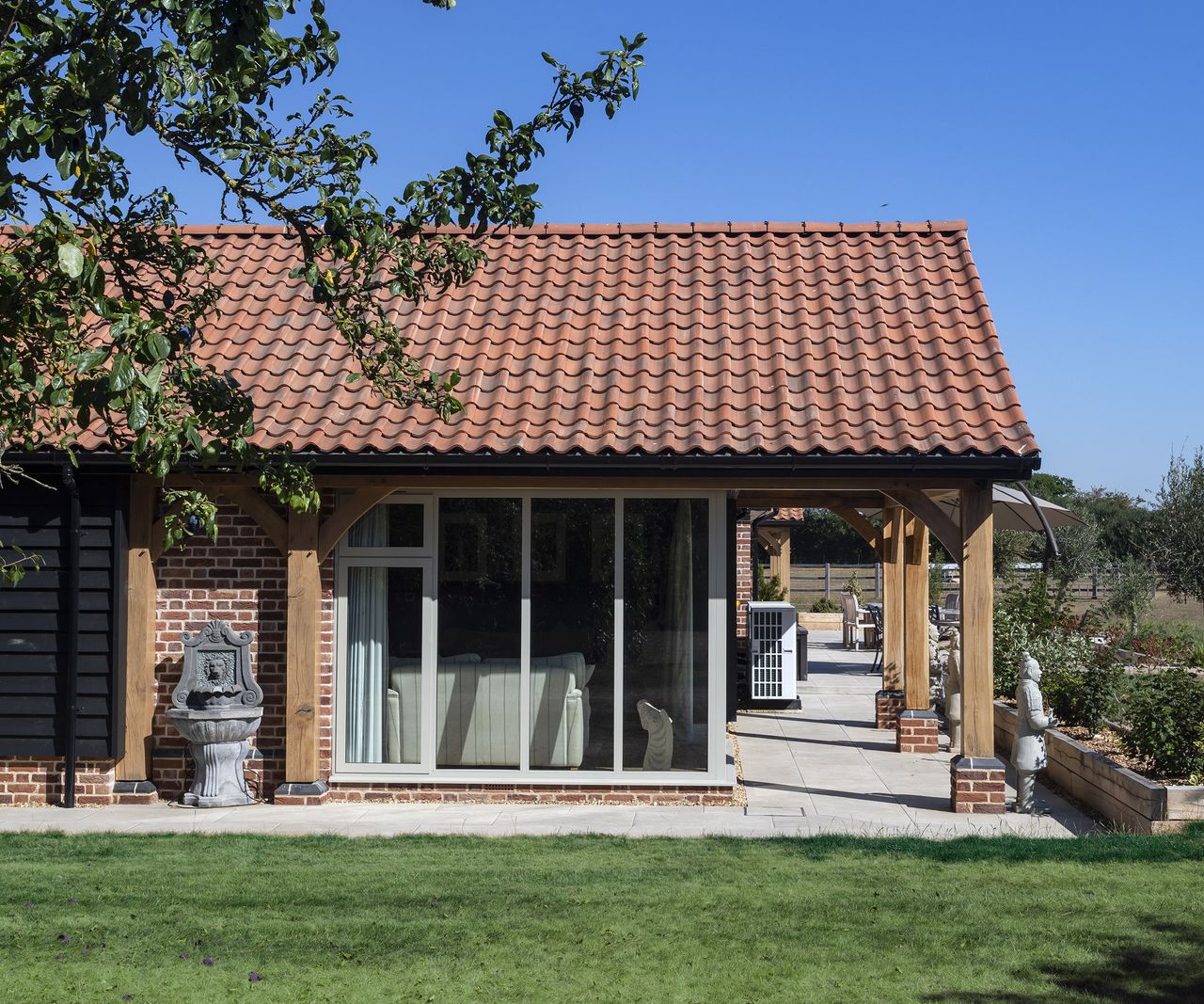 A pitched roof with extended roof creating a covered walkway