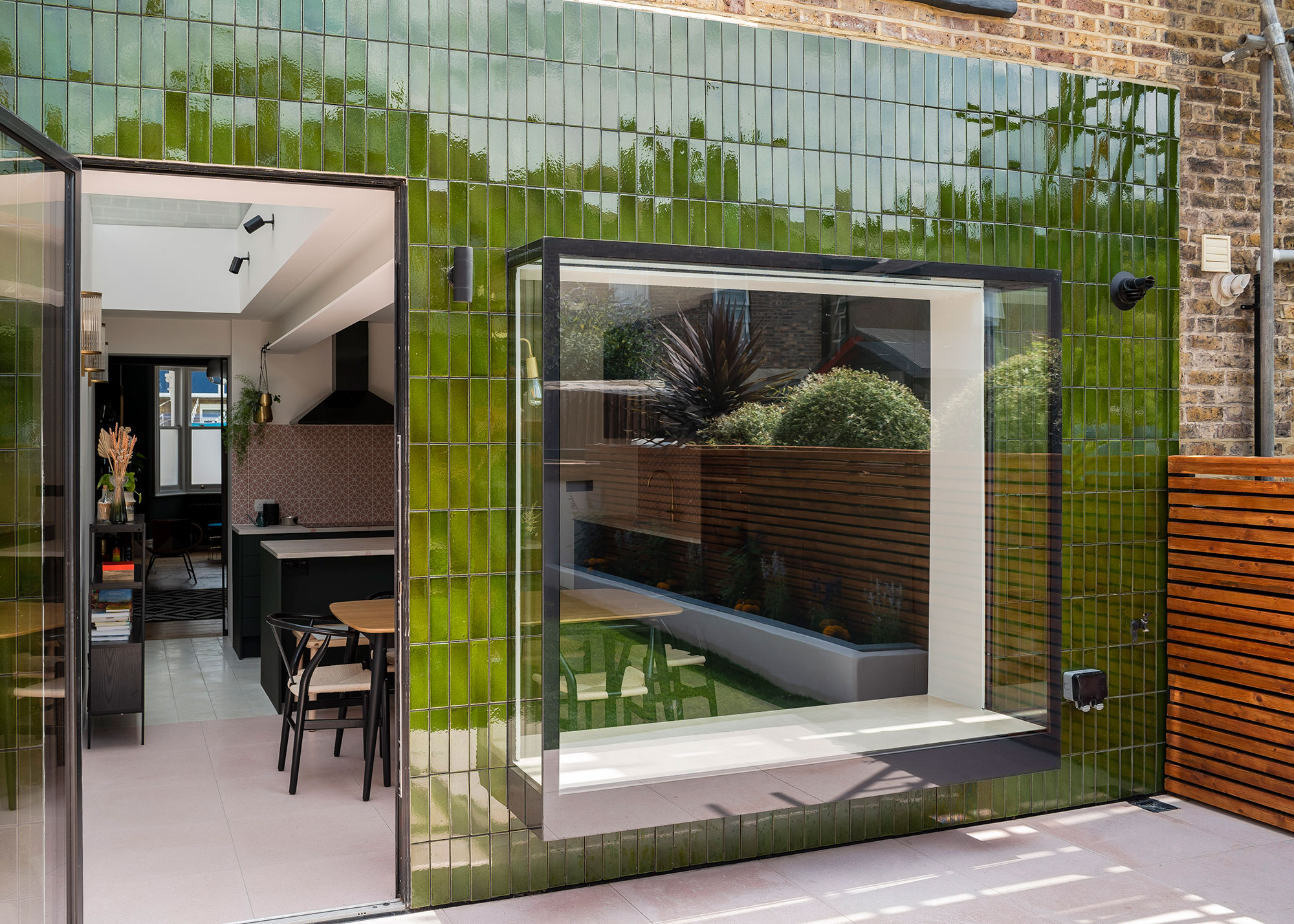 single storey rear extension with green tile cladding and oriel window