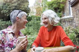 Two women chat with tea