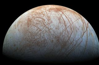 Could the surface features in Europa's crust reveal where comets have impacted and penetrated through the ice?