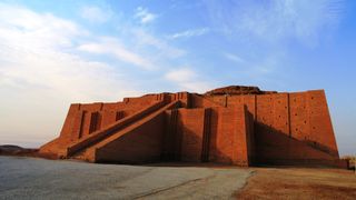 Here we see a restored temple, known as a ziggurat, from ancient Ur in what is now Iraq. A blue sky is in the background.