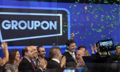 Groupon employees ring the opening bell in celebration of the company's IPO at the Nasdaq Market in New York. 
