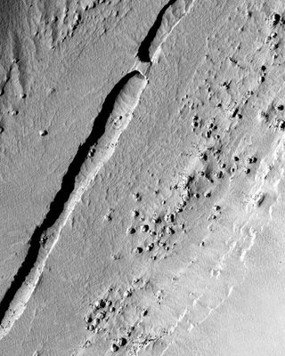 NASA's Mars Reconnaissance Orbiter snapped this shot of a trough running down the center of a valley in the Tartarus Colles region of Mars. Scientists think the structure originally formed as a lava tube.