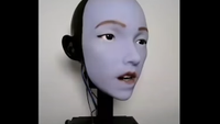 Screenshot of a robots face with lips parted,.