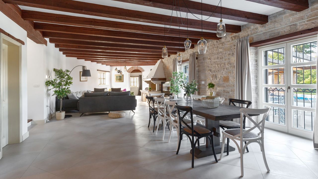 Living room with stone flooring and a dinner table