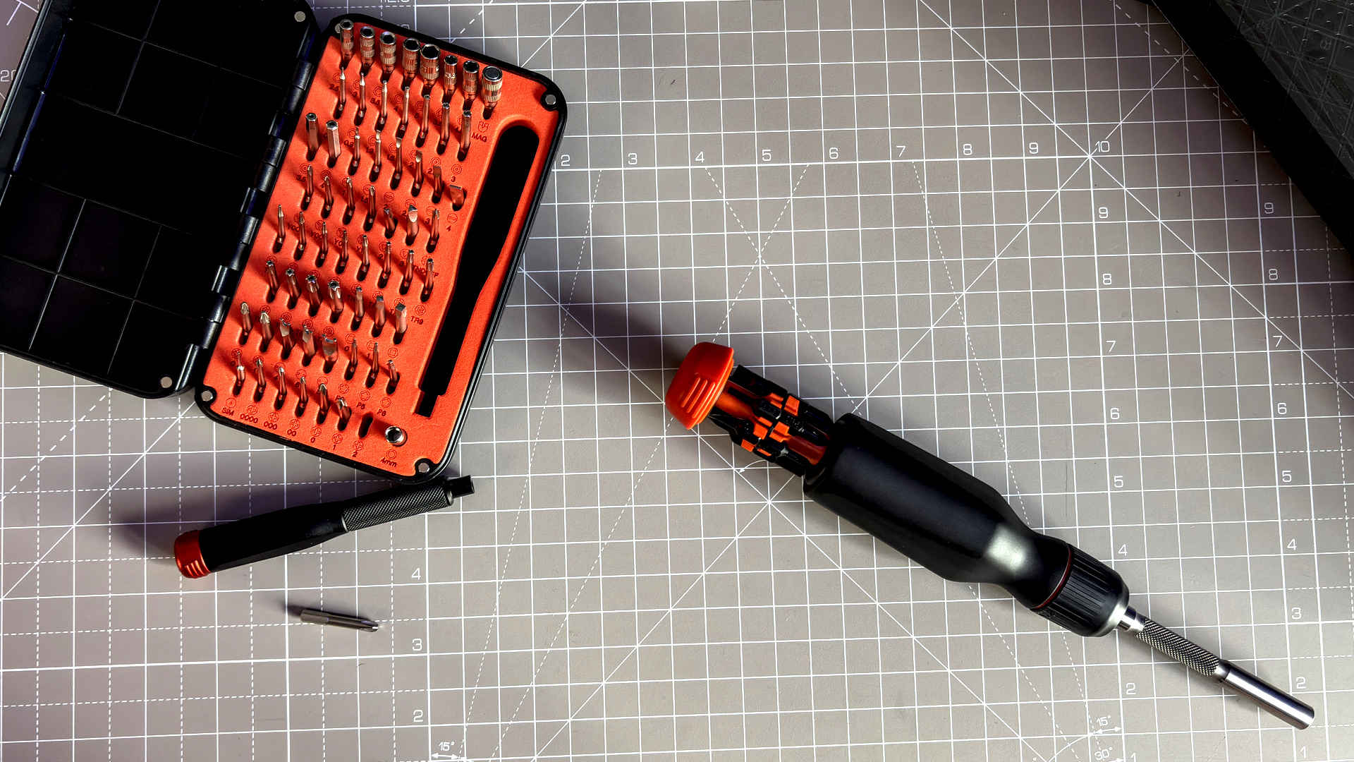 Two screwdrivers on a desk with orange highlights, sold by the YouTube channel Linus Tech Tips, or LTT for short.