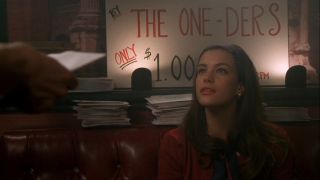 Liv Tyler looks up while selling records at a gig in That Thing You Do!