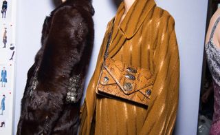 fur jacket and animal print bag