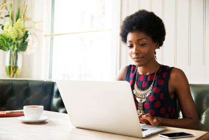 Woman using laptop at table