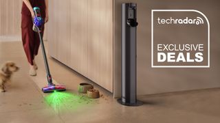 A woman using the Dyson V10 Konical vacuum to clean up spilt dog food in a kitchen. A TechRadar deal badge with "Exclusive Deals" text is on the right.