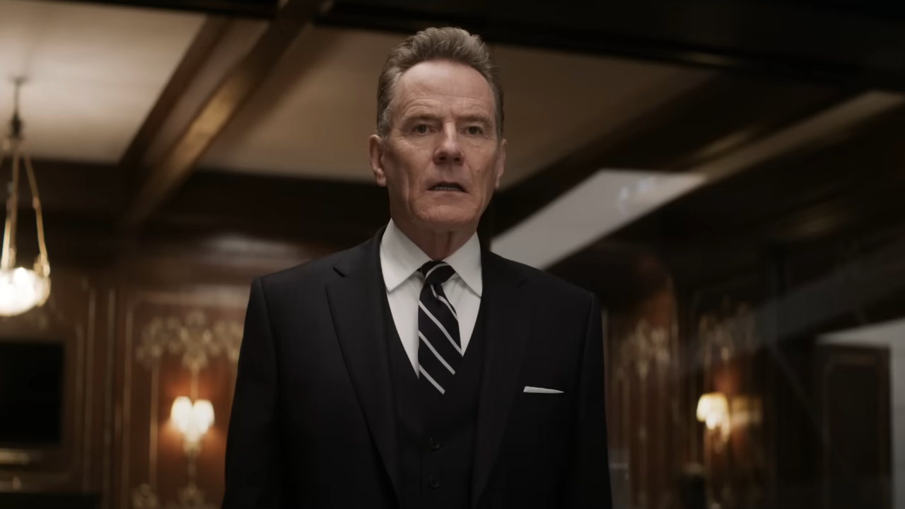 Bryan Cranston stands stunned in a nice room in Argylle.