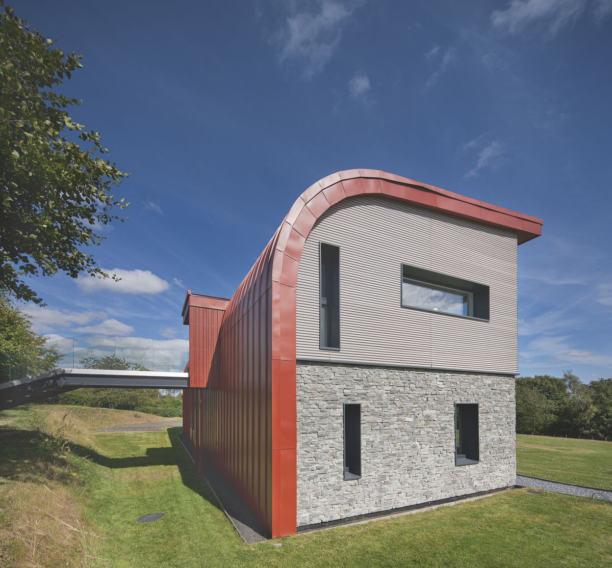 red curved roof on self build house