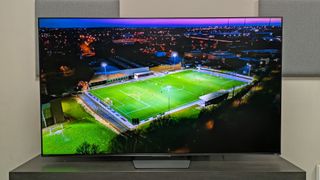Hisense U7S Pro taken central shot with footage of a football training ground at night aerial shot on screen 