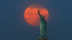 The Moon behind the Statue of Liberty