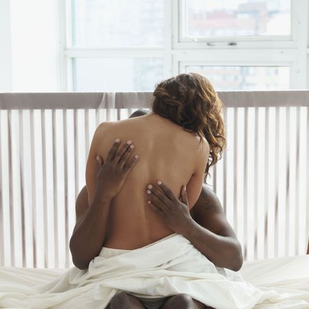 Woman and man hugging in bed