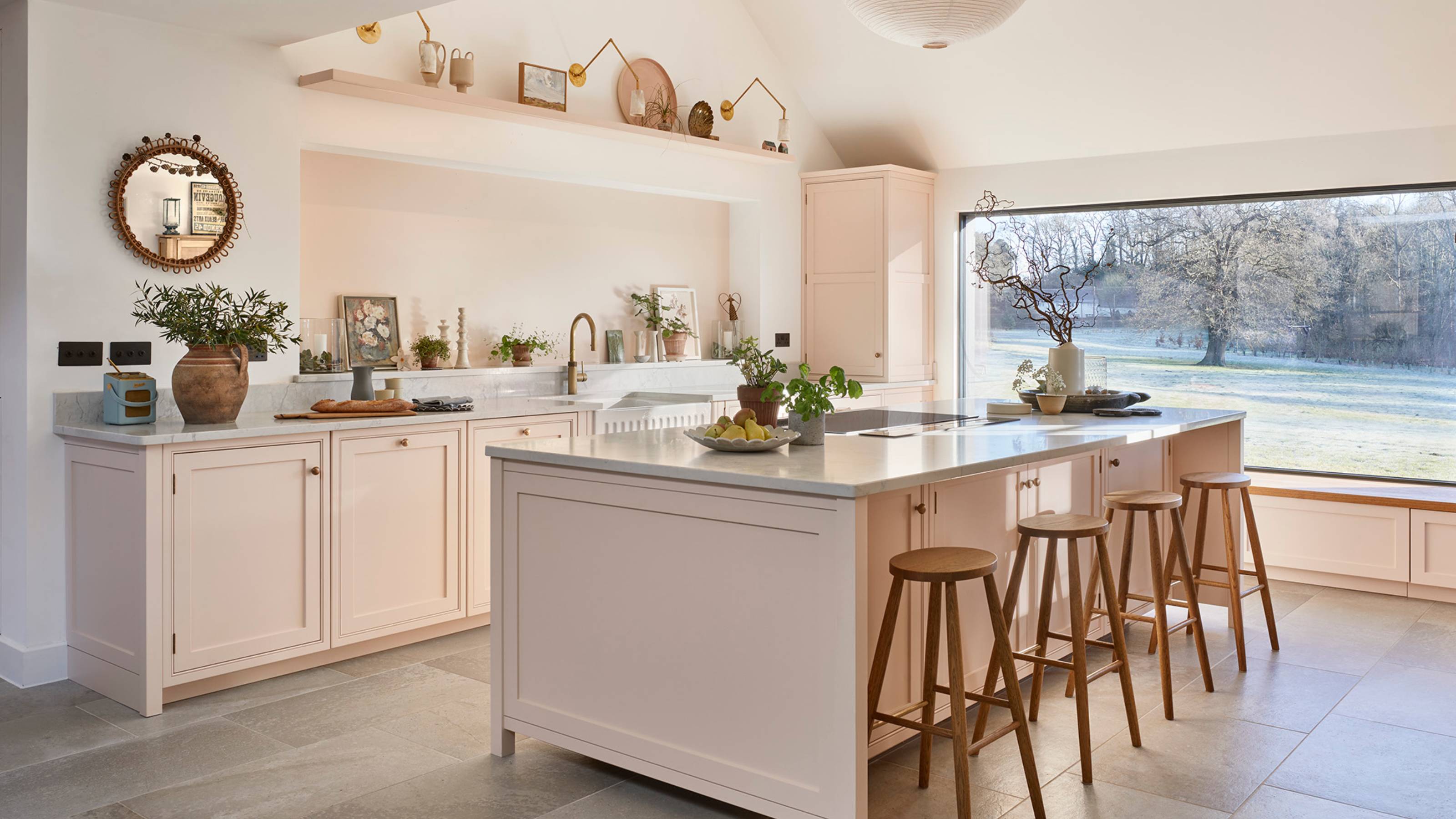 pale pink kitchen with an island and large picture window