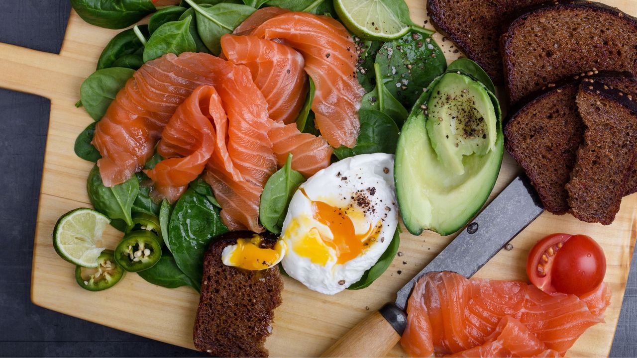 Foods included in the Nordic diet, including rye bread, salmon, eggs, and spinach
