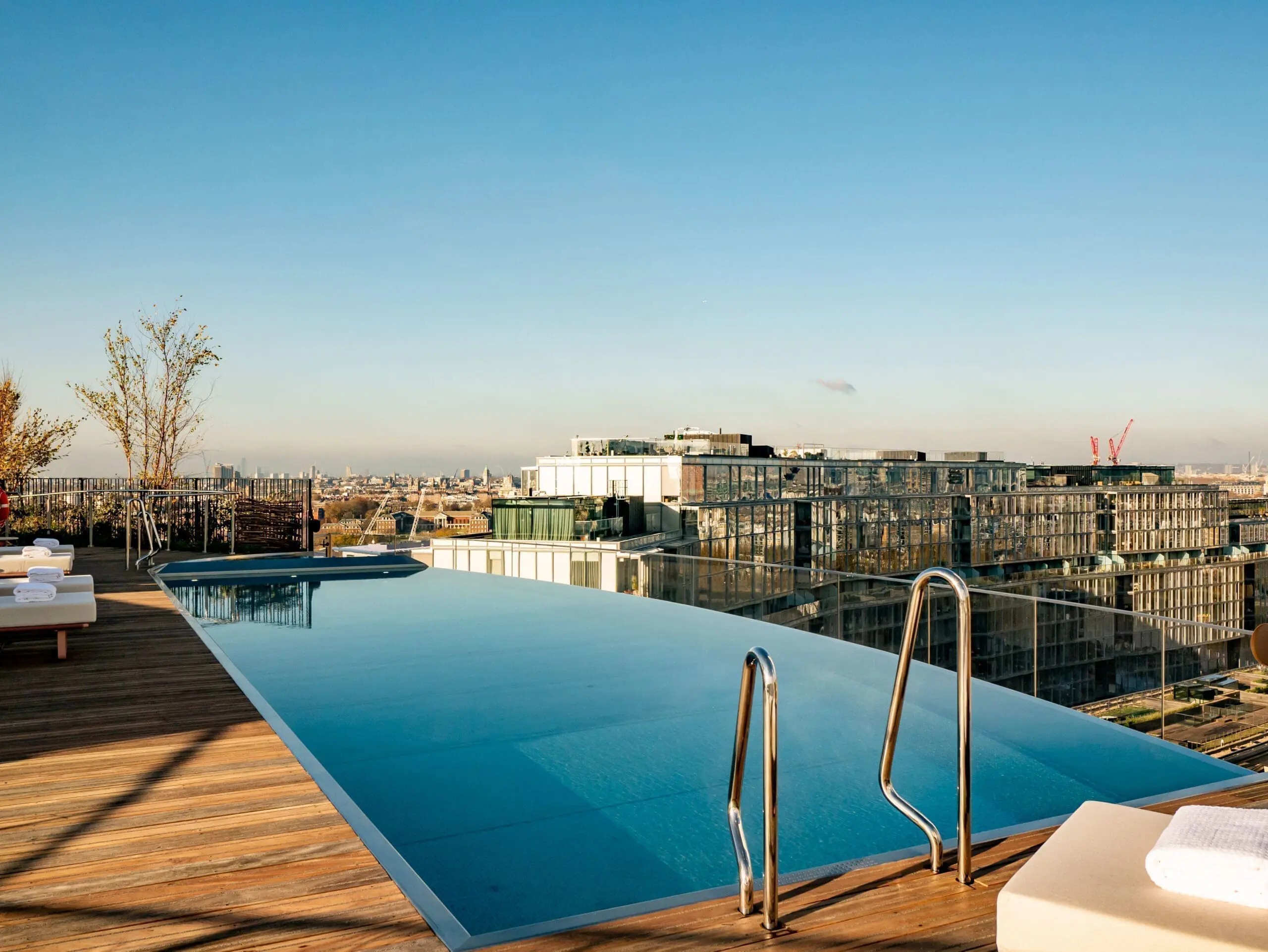 An infinity rooftop pool caught at sunset.