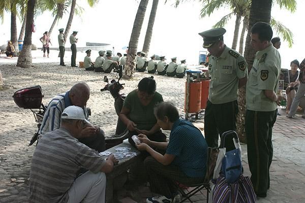 A game of cards on the beach for locals in Sanya.