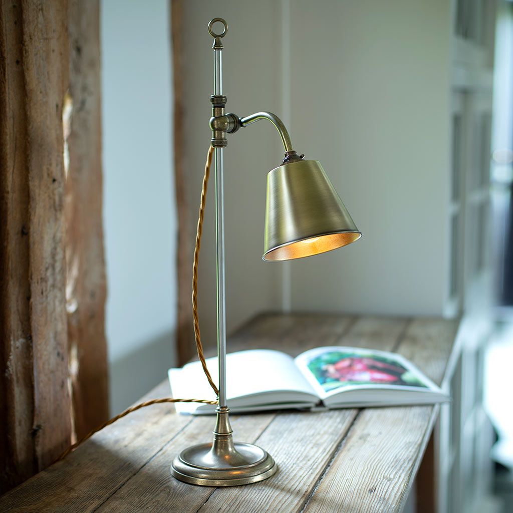 Desk lamp in antique brass by Jim Lawrence; lighting trends 2021